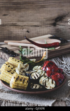 Homemade organic grilled summer vegetables on rustic table. Corn, pepper, onion, eggplant, zucchini. Vegetarian food concept Stock Photo