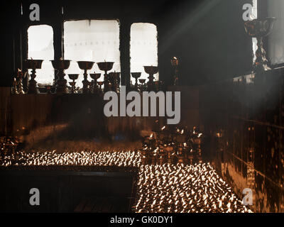 Candles burning in the Boudhanath Stupa in Nepal Stock Photo