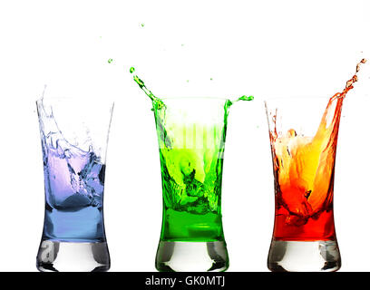 ice cube falling in colorful glasses Stock Photo