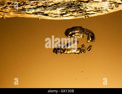 Air bubbles in water, similar to the liquid gold Stock Photo