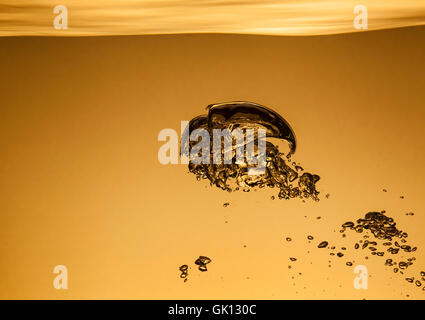Air bubbles in water, similar to the liquid gold Stock Photo
