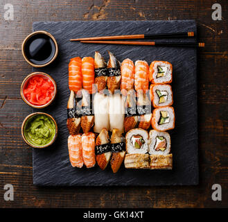 Sushi Set nigiri and sushi rolls on black stone slate plate board Stock Photo