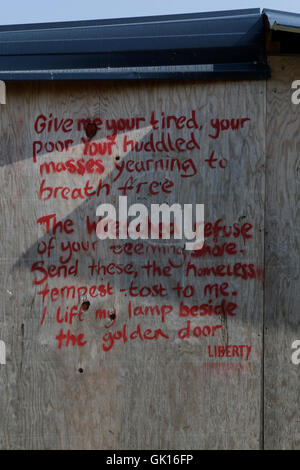 Calais, France. 17th Aug, 2016. Lines of 'The New Colossus' sonnet, normally associated with the Statue of Liberty. Are written on a hut in the old part of the camp that was knocked down earlier in the year by the French government. Over 9,000 refugees live in the Refugee camp in Calais, called the Jungle. They are all on their way to the UK and are stranded here, as the English Channel is heavily guarded with French and English police as well as high fences and barbed wire. Credit:  Michael Debets/Pacific Press/Alamy Live News Stock Photo