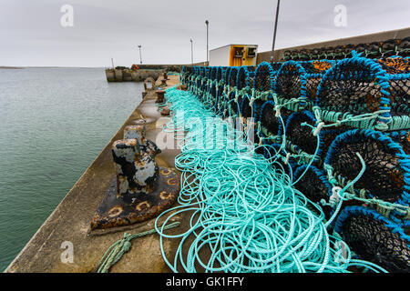 Lobster pots with new ropes stacked up on a pier at Blacksod on Belmullet Peninsula, County Mayo, in the west of Ireland Stock Photo