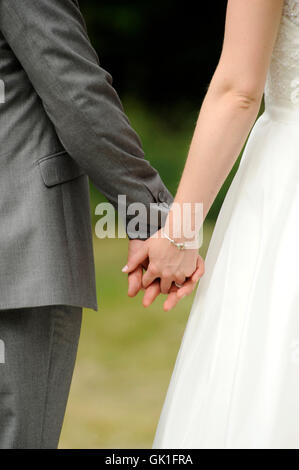 Newly wed couple holding hands Stock Photo