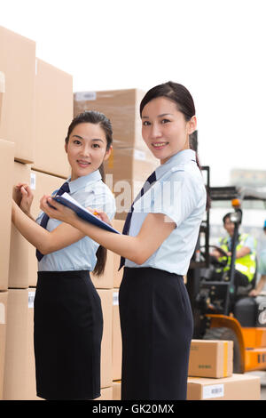 Logistics warehouse management personnel inspect the goods Stock Photo