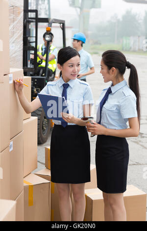 Logistics warehouse management personnel inspect the goods Stock Photo