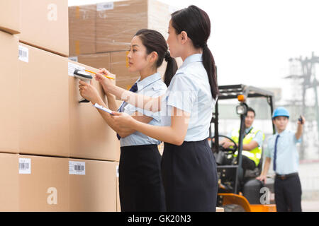 Logistics warehouse management personnel inspect the goods Stock Photo