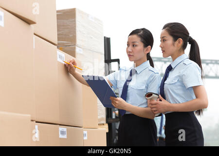 Logistics warehouse management personnel inspect the goods Stock Photo