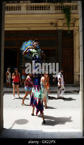 A clown walking on stilts in old Havana, Cuba. Stock Photo