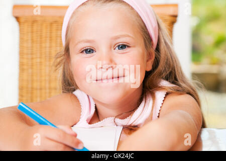 children doing homework in kitchen Stock Photo