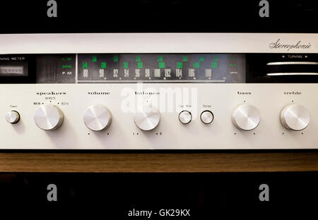 Old dusty Hi-Fi receiver with radio dial and silver buttons Stock Photo