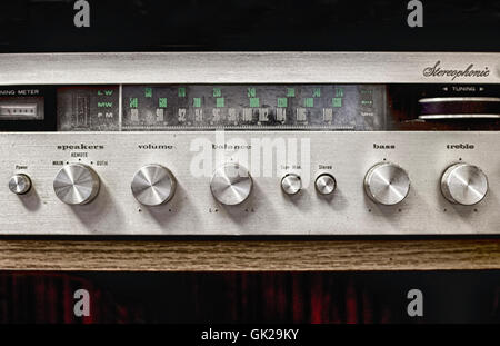 Old dusty Hi-Fi receiver with radio dial and silver buttons Stock Photo