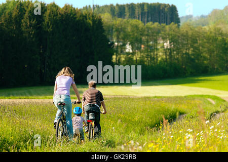 family rides a bike Stock Photo