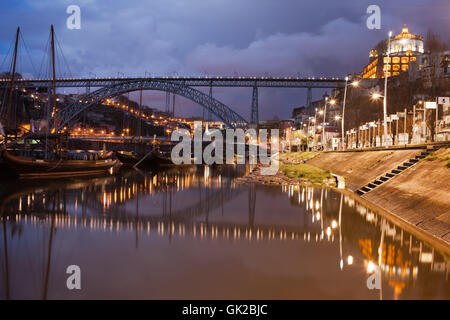 Portugal, city of Porto and Vila Nova de Gaia at night, Dom Luis I Bridge and Rabelo Boats on Douro River Stock Photo