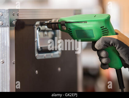 hands hold electric drill in workshops Stock Photo