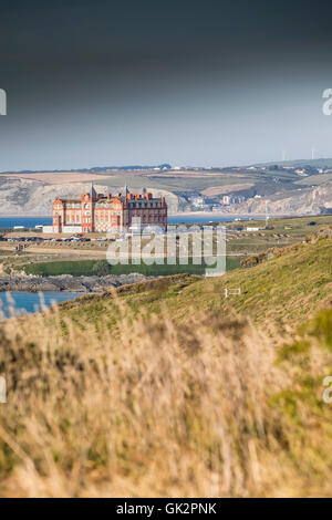 A distant view of the Headland Hotel seen from East Pentire in Newquay, Cornwall Stock Photo