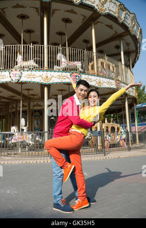 Young couple went to the amusement park Stock Photo