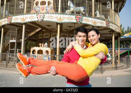 Young couple went to the amusement park Stock Photo