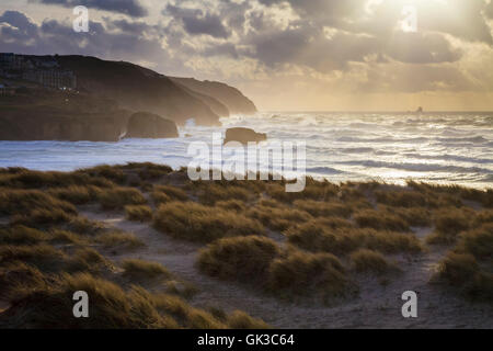 The setting sun captured from the sand dunes at Perranporth on the north coast of Cornwall. Stock Photo