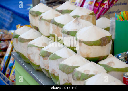 Coconut juice and coconut water packing thai style for sale at local market in Sakon Nakhon, Thailand Stock Photo