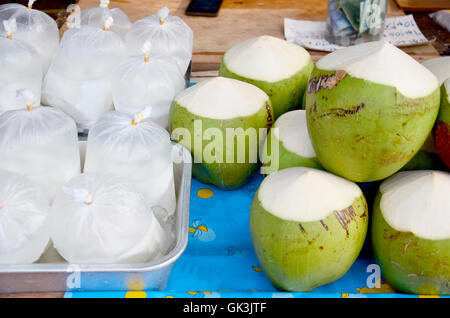 Coconut juice and coconut water packing thai style for sale at local market in Sakon Nakhon, Thailand Stock Photo