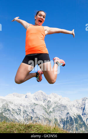 Pretty women joyfully jumping in the mountains Stock Photo