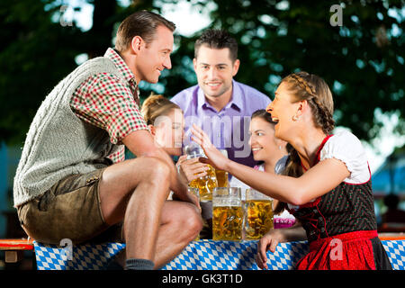 in beer garden - friends drinking beer Stock Photo