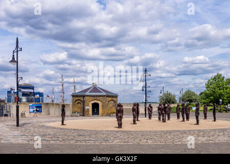 Woolwich, London.Royal Arsenal Riverside. Sculpture, The assembly by Peter Burke - 16 Cast iron Figures , Old Guardhouse & pier Stock Photo