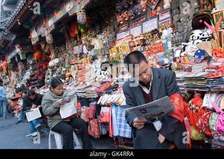 2005, Beijing, China --- People Reading Newspapers at Street Market --- Image by © Jeremy Horner Stock Photo