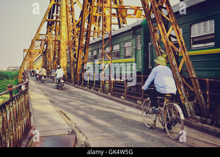 Hanoi, Vietnam - 18 November,2012: People and the train go across Long Bien bridge Stock Photo