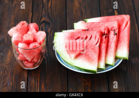 Slices of watermelon on plate and glass with heartshape Stock Photo