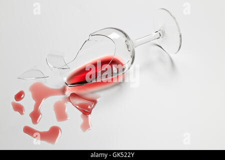 Broken Red Wine tasting glass with wine Stock Photo