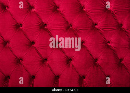 Red burgundy velvet capitone textile background, retro Chesterfield style checkered soft tufted fabric furniture diamond pattern Stock Photo