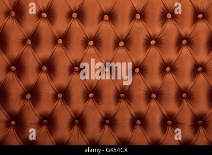 Brown capitone textile background, retro Chesterfield style checkered soft tufted fabric furniture diamond pattern decoration wi Stock Photo
