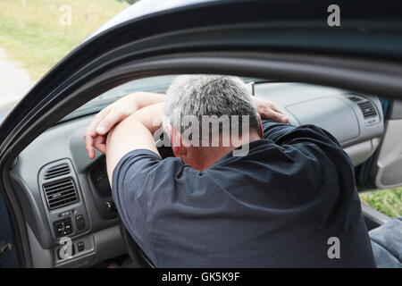Tired driver sleeping in car. Stock Photo
