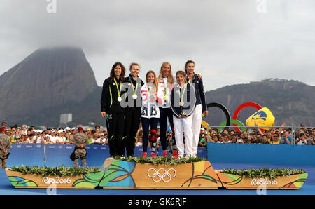 Great Britain's Hannah Mills (centre left) and Saskia Clark (centre right) with celebrate on the podium with their gold medals alongside silver medallists, New Zealand's Jo Aleh and Polly Powrie and bronze medalists France's Camille Lecointre and Helene Defrance from the Women's 470 Race at Marina da Gloria on the thirteenth day of the Rio Olympic Games, Brazil. Stock Photo