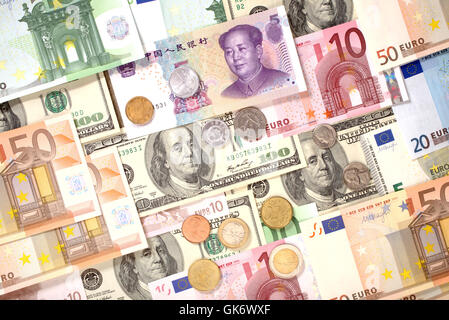 Dollars, Euro and Yuan banknotes and coins background Stock Photo