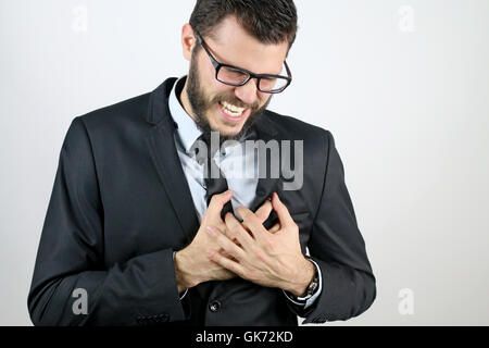 young man having a heart attack Stock Photo