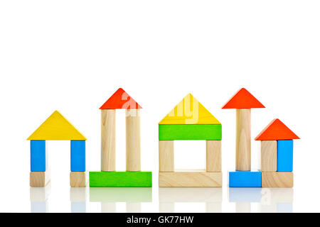 Colorful build houses with wooden blocks isolated over white background ...