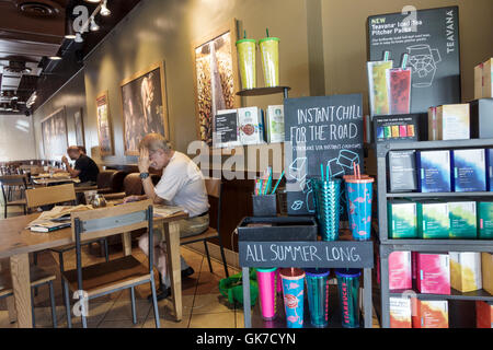 Miami Florida,Westchester,Starbucks Coffee,company,coffeehouse,cafe,chain,table,chair,adult,adults,man men male,customer,products,brand,promotion,Teav Stock Photo