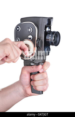 Film enthusiasts operator starts spring retro mechanical amateur cameras in the hands isolated white Stock Photo