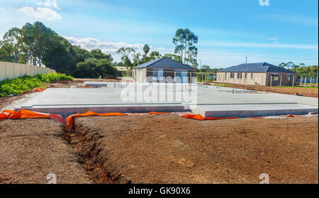 view of construction site house foundation and new home framing in ...