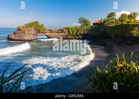 Pura Batu Bolong temple on the beatiful rock in the morning light, Tanah Lot, Bali, Indonesia. Stock Photo