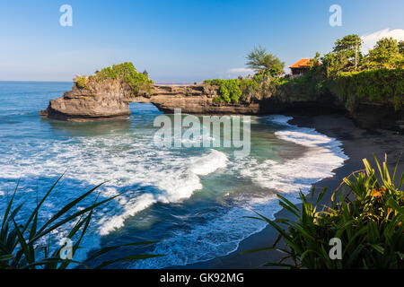 Pura Batu Bolong temple on the beatiful rock in the morning light, Tanah Lot, Bali, Indonesia. Stock Photo