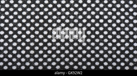 Dark knitted fabric with white polka dots, background Stock Photo