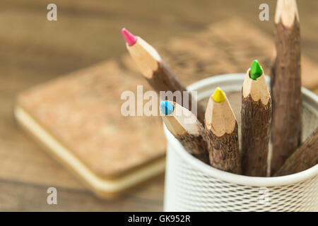 colored natural wooden pencils in metal office pencil holder Stock Photo