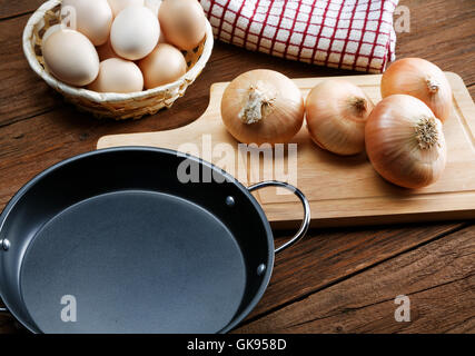 Still life with onions and quail eggs on a kitchen table Stock Photo