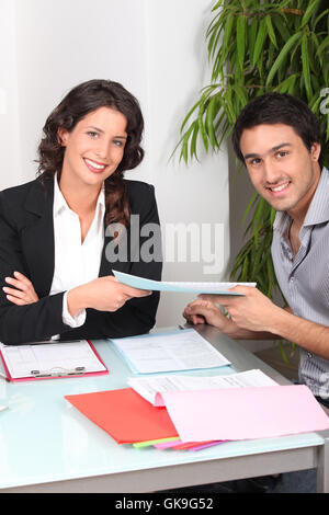 Businesswoman signed a contract loan agreement. Hand signing legal or  insurance document or business contract on grey desk. Calculating loan  fees. Loa Stock Photo - Alamy