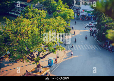 Hanoi,Vietnam - 09 May,2014: People go in the street in sunny afternoon day at Hoan Kiem lake Stock Photo